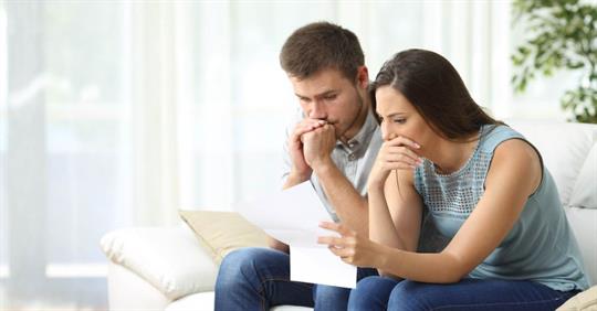 Worried couple reading a foreclosure notice