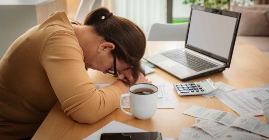 Frustrated and dissapointed woman calculating finances at hom