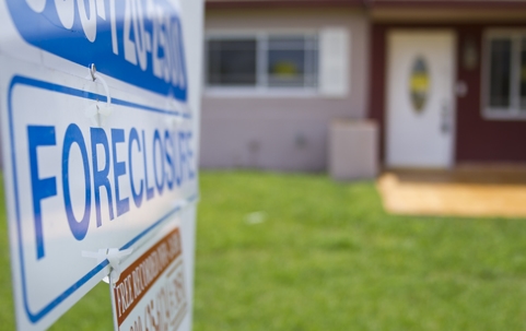 Foreclosure sign outside a condemned property.